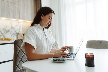 Businesswoman using laptop at table
