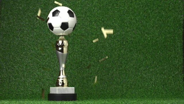 Soccer champion trophy revolves around itself with falling golden confetti. Video 4K