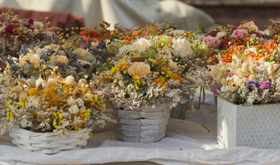 Arranged flowers at a stall at the Prague Naplavka street farmers market. No people, selective focus.