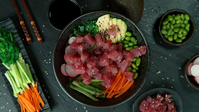 Super Slow Motion Shot of Fresh Tuna Cuts Falling into Poke Bowl at 1000fps.