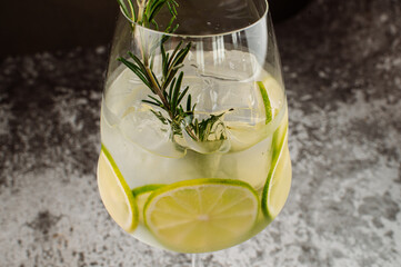 Transparent cocktail with lime and ice