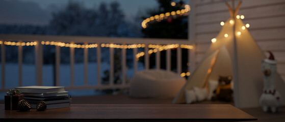 Copy space on dark wood tabletop over beautiful terrace with Christmas decor.