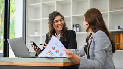 Happy caucasian businesswoman enjoy talking with her colleague while working together