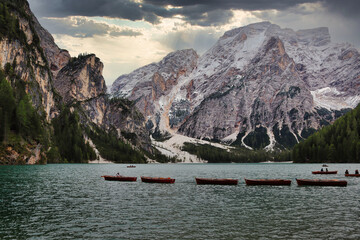Boats float on the Pragser Wildsee in the Dolomites in Italy