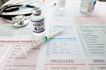 Coronavirus vaccine bottle with the name of the fourth vaccine on the label and dose syringe....
