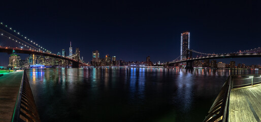Fototapeta na wymiar Brooklyn and Manhattan bridges at night from Empire Fulton Ferry Park