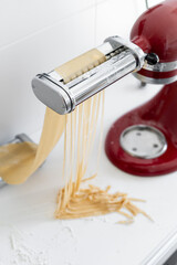 raw pasta maker robot cut spaghetti  handmade white background