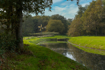 Fototapeta na wymiar windmill and canal, colors, fall, netherlands, rheebruggen, uffelte, 