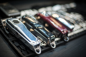 Close-up detailed view of hair trimmers and accessories in a professional hairdressing and...