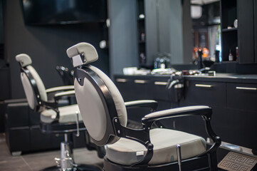 Detailed view of the hairdressing chair and the ambient in a professional hairdressing and...