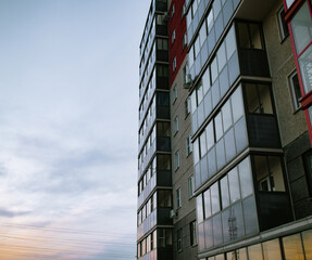 Multi-storey residential building in perspective against the background of the evening sky