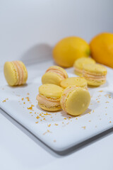 Lemon yellow macarons, white dish, french dessert