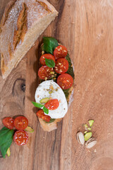 tomato cheese green basil mozzarella bread toast wood table