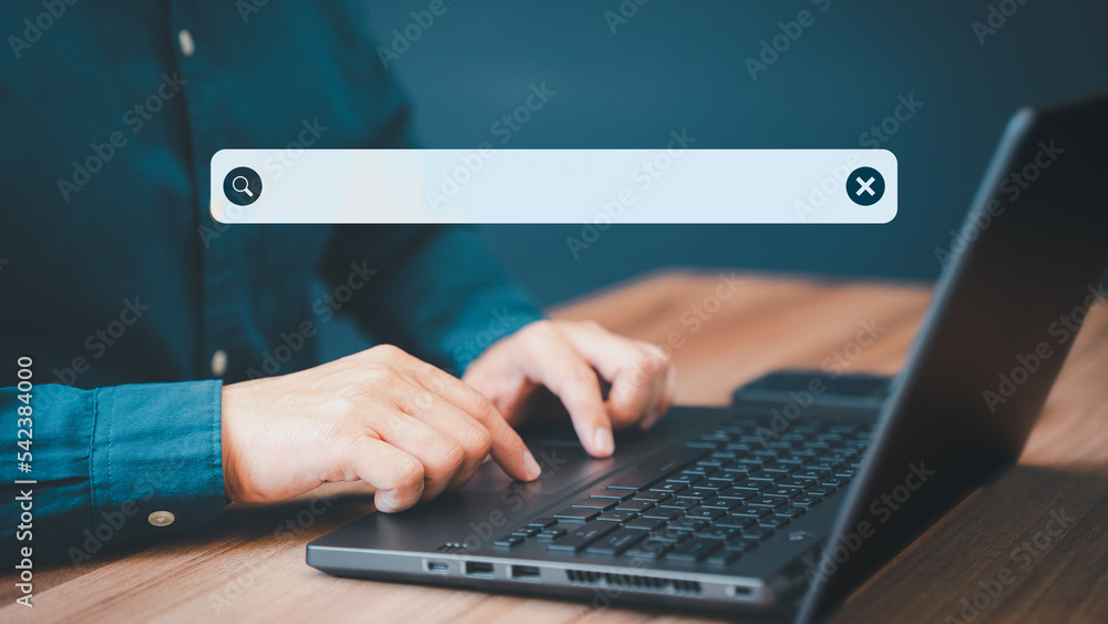 Poster Businessman's hand working with computer laptop on desk in home. Searching Browsing Internet Data Information with blank search bar. Search Engine Optimization SEO Networking Concept.