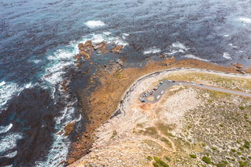 aerial view of "Cape of Good Hope" The most south-western point of the African continent. Cars parking next to the famous sign, people hiking and walking around - South Africa aerial landscape