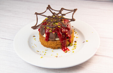 Chocolate sphere and its vanilla ice cream on its Breton shortbread and raspberry coulis. Happy Halloween, A bloody dessert for a successful Halloween evening, High quality photo