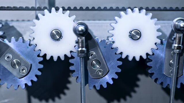 Close-up of steel gears spinning inside complex engine mechanism. Mechanics, teamwork, steampunk concept.