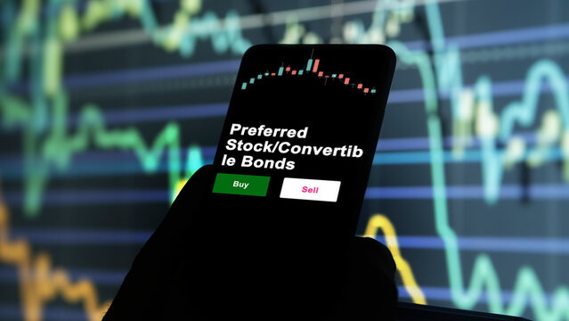 An Investor's Analyzing The Preferred Stock Convertible Bonds Etf Fund On Screen. A Phone Shows The ETF's Prices LargeCap Equity To Invest