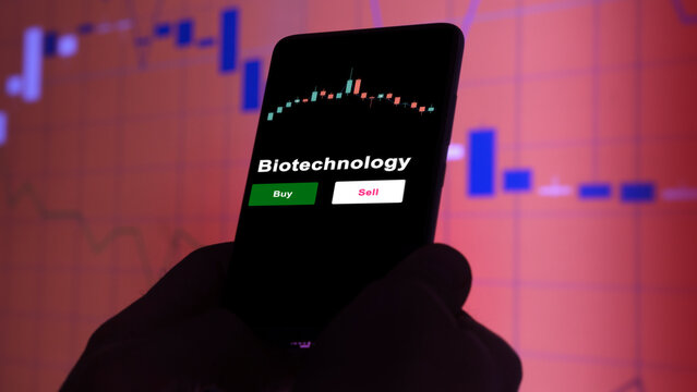 An Investor's Analyzing The Biotechnology Etf Fund On Screen. A Phone Shows The ETF's Prices Biotechnology To Invest