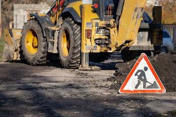 road sign warning about work on the road