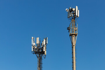 cell tower with antenna against blue sky