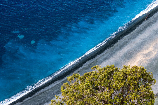 Grey stone beach on Corsica in Nonza