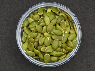 Green pumpkin seeds in a bowl 