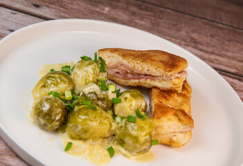 Recipe for homemade chicken fillet cordon bleu style with Brussels sprouts. High quality photo