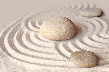 Fototapeta na wymiar Zen garden meditation stone background with stones and lines in sand for relaxation balance and harmony spirituality or spa wellness