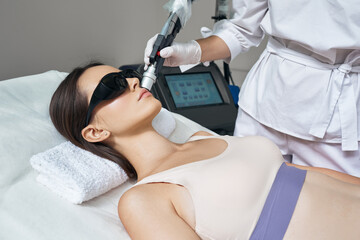 Facial laser hair removal. Beautiful woman during laser hair removal and laser epilation to lips area on her face