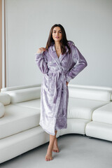 Young healthy serene woman girl relaxing in bathrobe and spa towel after having bath shower at home. Beauty treatment, rest and body care procedures.