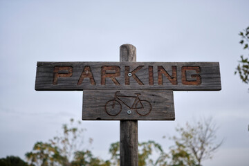 Ecological bicycle parking marked with a wooden post.