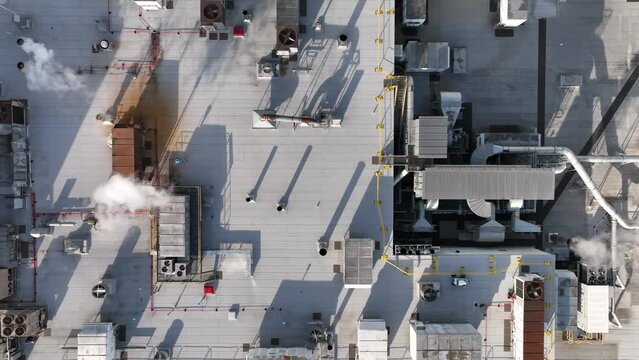 Energy efficiency building. Rooftop HVAC units on factory plant. Top down aerial of manufacturing plant.
