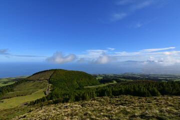 Fototapeta premium Clouds Floating Over Lush Landscape in the Azores