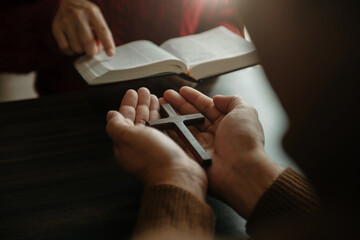 Woman's hand with cross .Concept of hope, faith, christianity, religion, church and pray to God. on...