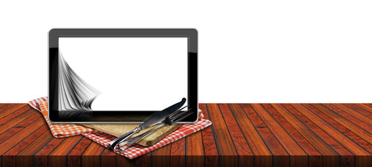 Blank digital tablet computer with white or transparent screen for recipes or food menu. On a wooden kitchen counter with a cutting board, checkered tablecloth and silver cutlery, png.
