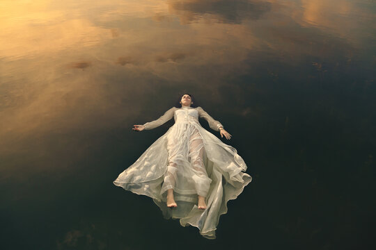 Woman sleeping among sunset clouds