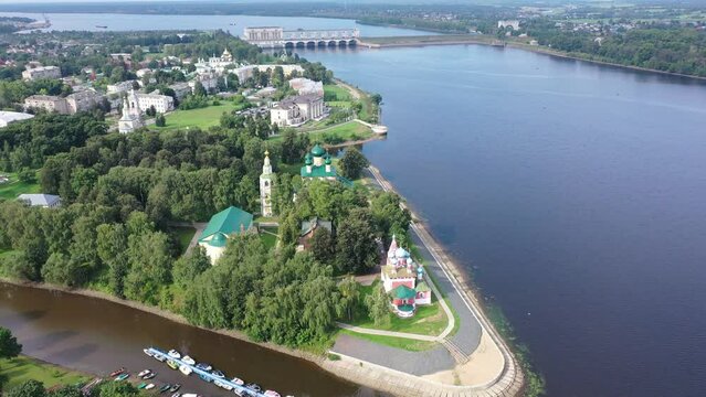 Summer aerial view of modern Uglich cityscape overlooking architectural complex of Kremlin with Transfiguration Cathedral and Church of Dimitry Tsarevich on bank of Volga, Russia