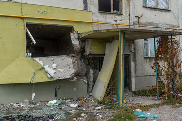 War in Ukraine. 2022 Russian invasion of Ukraine. Entrance of an apartment building destroyed by...