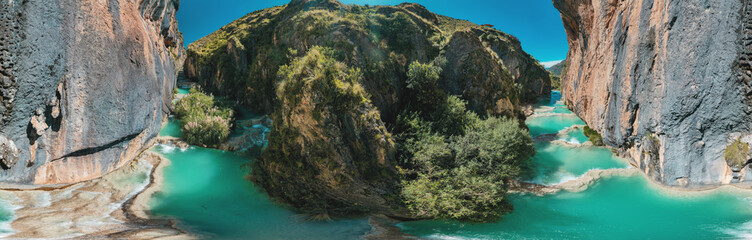 Panoramic view of the turquoise natural pools of Millpu in Huancaraylla. Turquoise lagoons near...