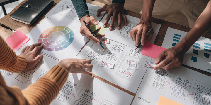 Team ux designer creative graphic planning application development a prototype smartphone layout.