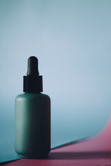 Skin care lotion or serum on blue background.