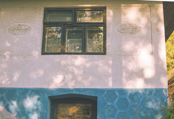 Facade of old peasant house in autumn season.