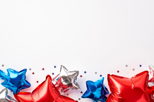 USA Independence Day concept. Top view photo of red white blue balloons and star shaped confetti on isolated white background with empty space