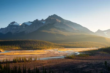 Foto auf Leinwand Mountain landscape at dawn. Sunbeams in a valley. Rivers and forest in a mountain valley at dawn. Natural landscape with bright sunshine. High rocky mountains. Banff National Park, Alberta, Canada. © biletskiyevgeniy.com