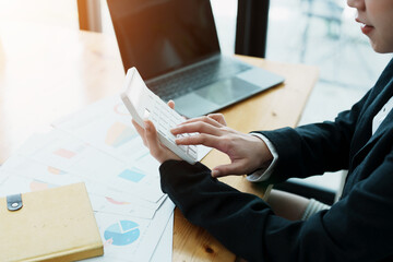 financial, Planning, Marketing and Accounting, portrait of Asian employee checking financial statements using documents and calculators at work