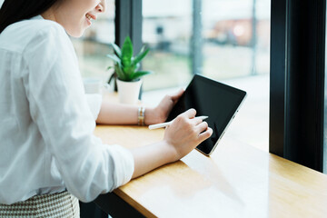 Portrait of a beautiful Asian teenage girl using a tablet computer