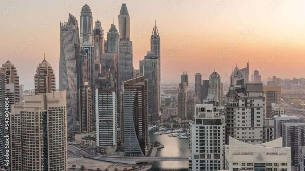 Poster view of various skyscrapers in tallest recidential block in dubai marina aerial night to day transit