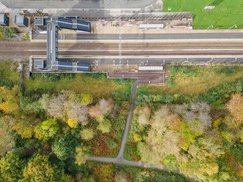 Aerial view of Kirkstall Forge Train Station and railway tracks and autumn trees