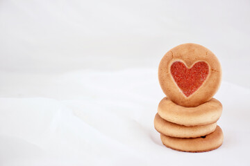 Sponge cookies with a heart and a white mug. Background for lovers on Valentine's Day